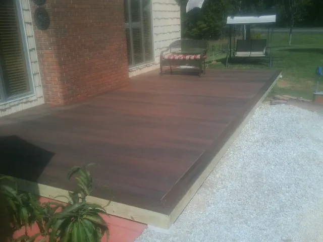 Freshly stained wood deck built against a brick home in Greenfield